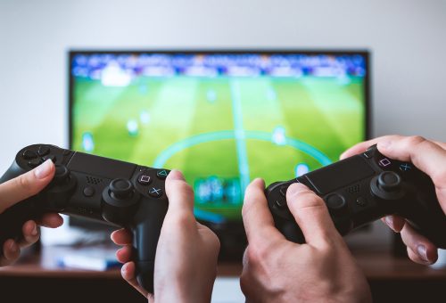 Two people playing a games console
