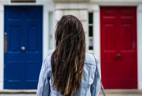Lady choosing between 2 doors