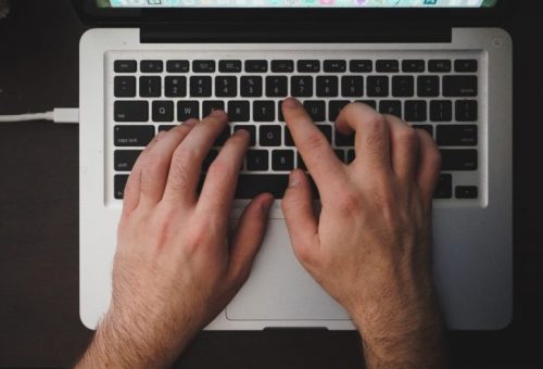 Person typing on laptop computer