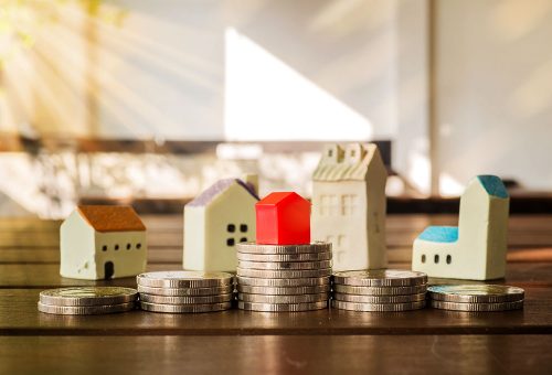 Stack of coins with house on top