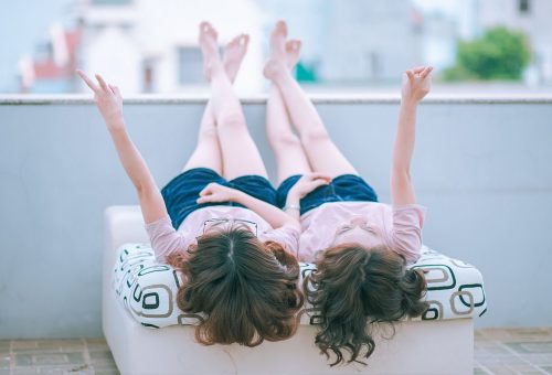 Friends sitting on bed