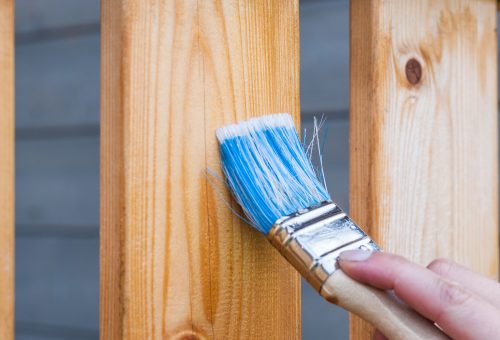 Paintbrush being used on wood