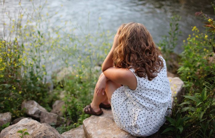 Person sitting near water