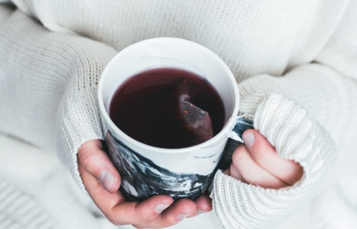 Cup of tea being held