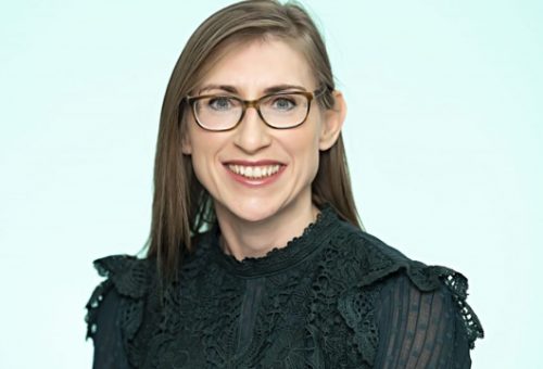 Headshot of a Coreco team member wearing glasses