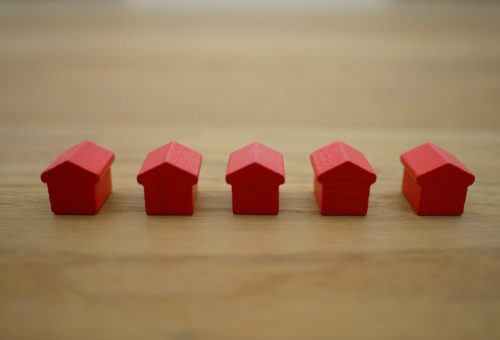 Row of small red wooden house models