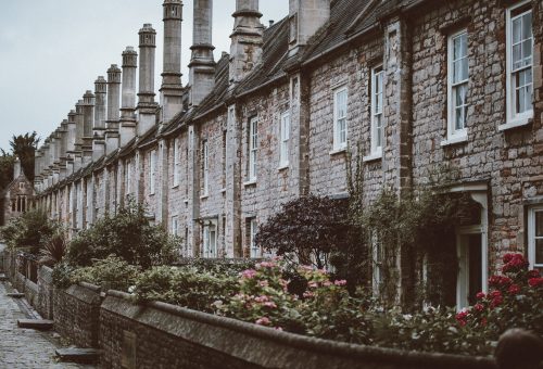 Row of ivy-covered stone cottages
