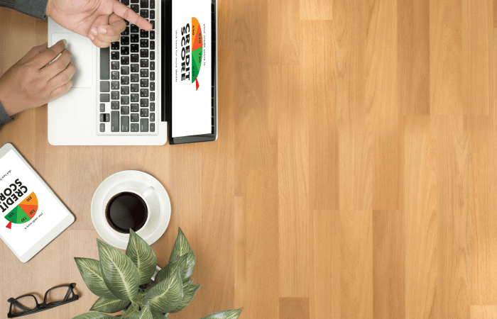 Laptop on a wooden desk with coffee, aerial view