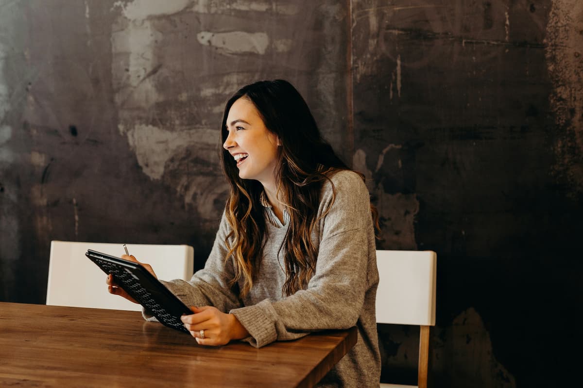 Smiling woman working on a tablet