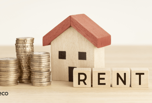 Stacked coins beside a model house with a Rent sign