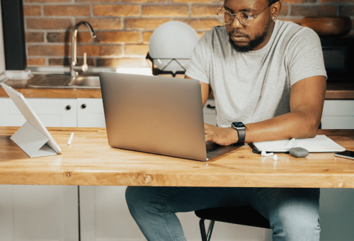Man using a laptop at a desk