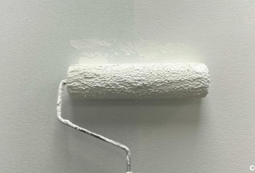 Paint roller covered in white paint