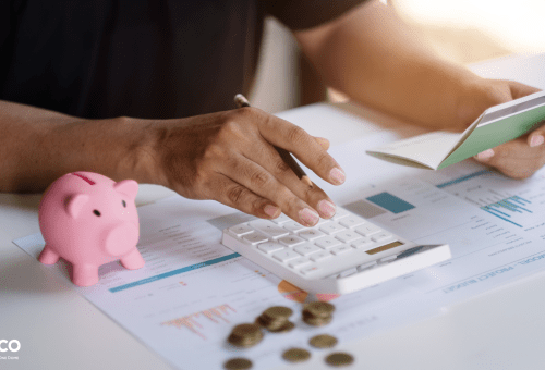 Hands with a piggy bank and calculator, budgeting concept