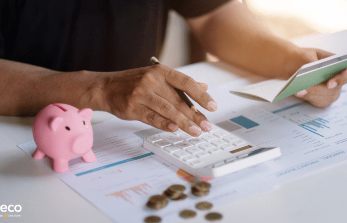 Hands with a piggy bank and calculator, budgeting concept